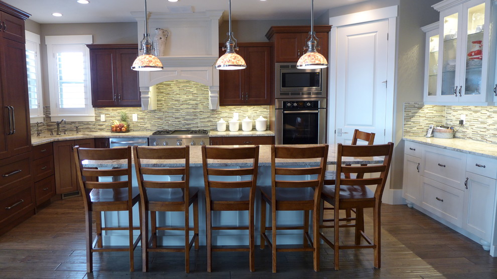Klassische Küche in U-Form mit Unterbauwaschbecken, weißen Schränken, Granit-Arbeitsplatte, bunter Rückwand und Küchengeräten aus Edelstahl in Salt Lake City