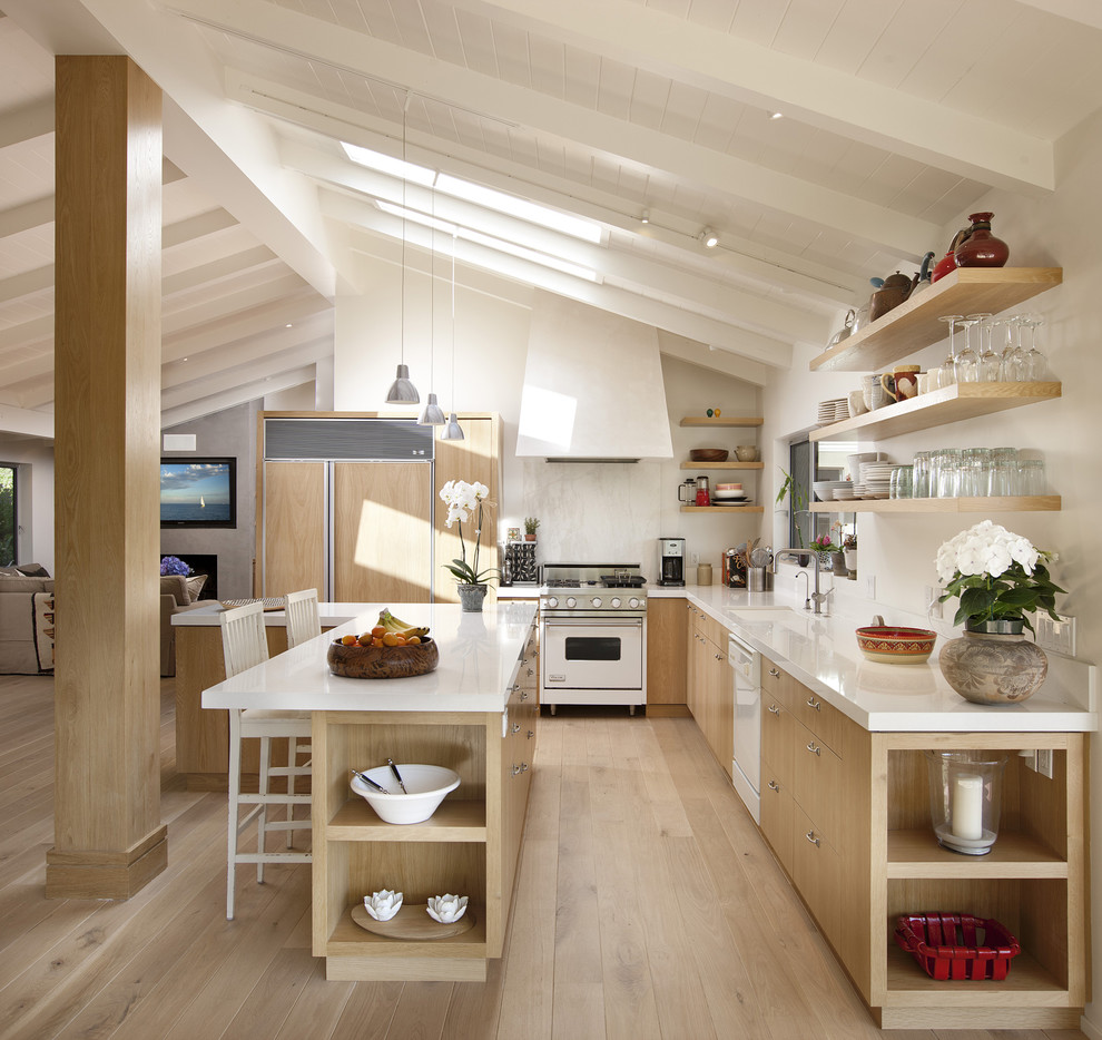 Mid-sized trendy l-shaped light wood floor and beige floor open concept kitchen photo in Santa Barbara with flat-panel cabinets, light wood cabinets, quartz countertops, white backsplash, stone slab backsplash, an island and paneled appliances