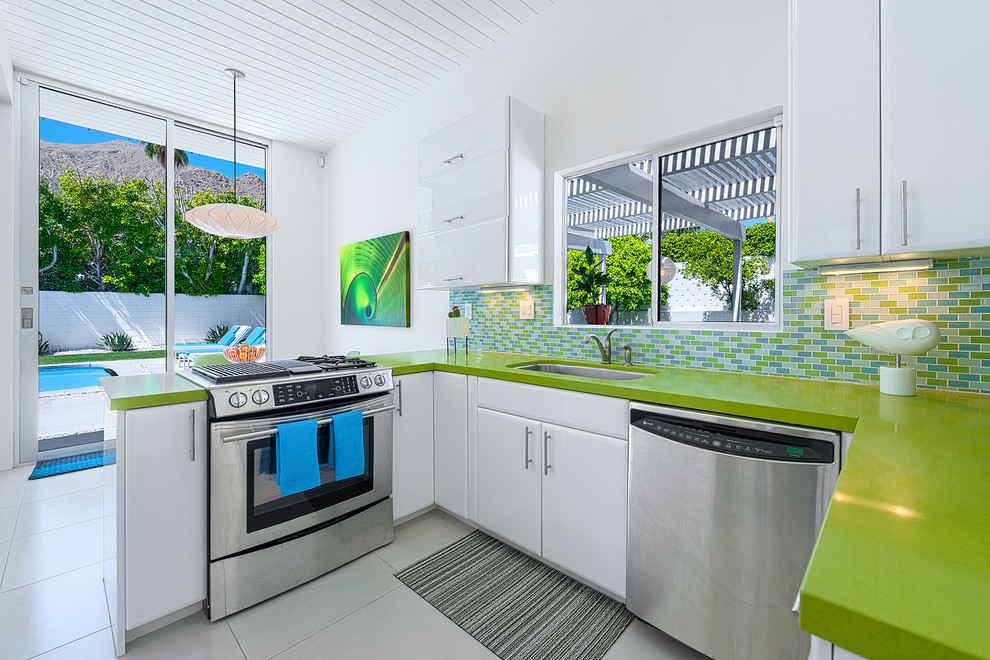 Kitchen - modern kitchen idea in Los Angeles with stainless steel appliances and green countertops