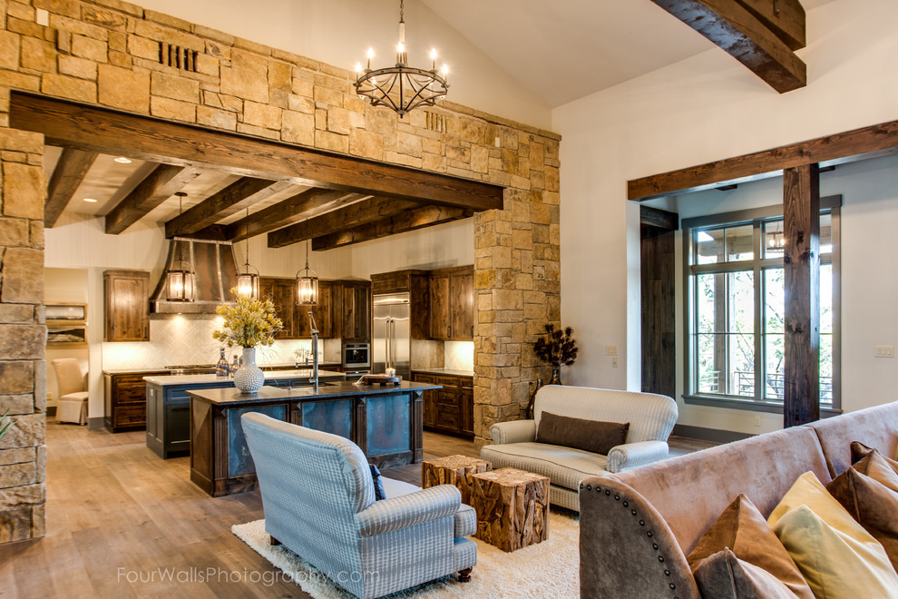 Large mountain style u-shaped medium tone wood floor open concept kitchen photo in Austin with a farmhouse sink, shaker cabinets, dark wood cabinets, soapstone countertops, beige backsplash, ceramic backsplash, stainless steel appliances and two islands
