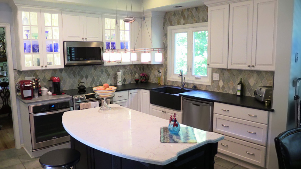 Eat-in kitchen - mid-sized traditional l-shaped porcelain tile eat-in kitchen idea in Baltimore with a farmhouse sink, raised-panel cabinets, white cabinets, soapstone countertops, multicolored backsplash, ceramic backsplash, stainless steel appliances and an island
