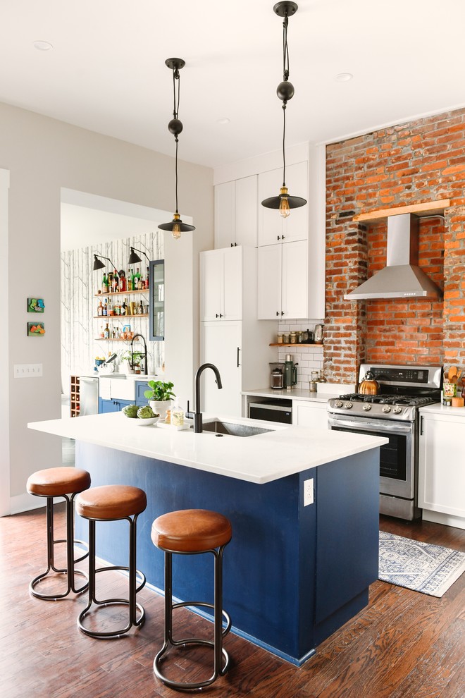 Eat-in kitchen - mid-sized transitional l-shaped dark wood floor and brown floor eat-in kitchen idea in Other with an undermount sink, shaker cabinets, blue cabinets, quartz countertops, white backsplash, subway tile backsplash, stainless steel appliances, an island and white countertops
