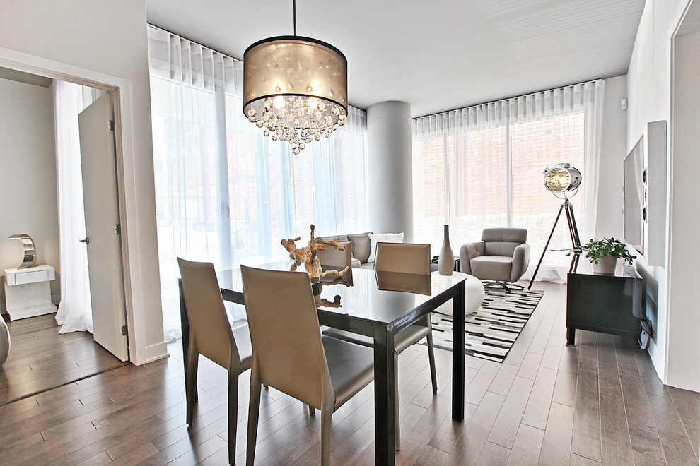 Immagine di una sala da pranzo minimalista con pavimento in legno massello medio
