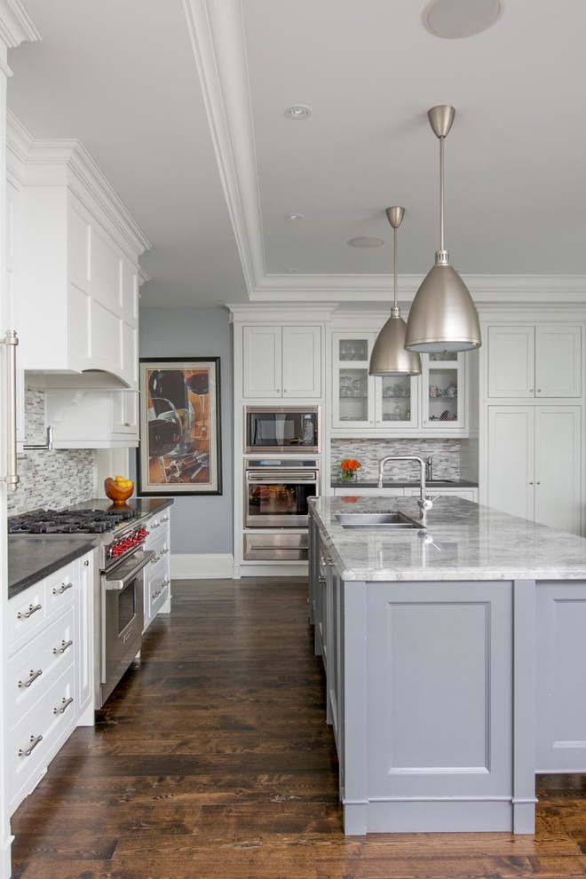 Inspiration for a traditional grey and white galley kitchen in Toronto with a double-bowl sink, recessed-panel cabinets, white cabinets, grey splashback and stainless steel appliances.