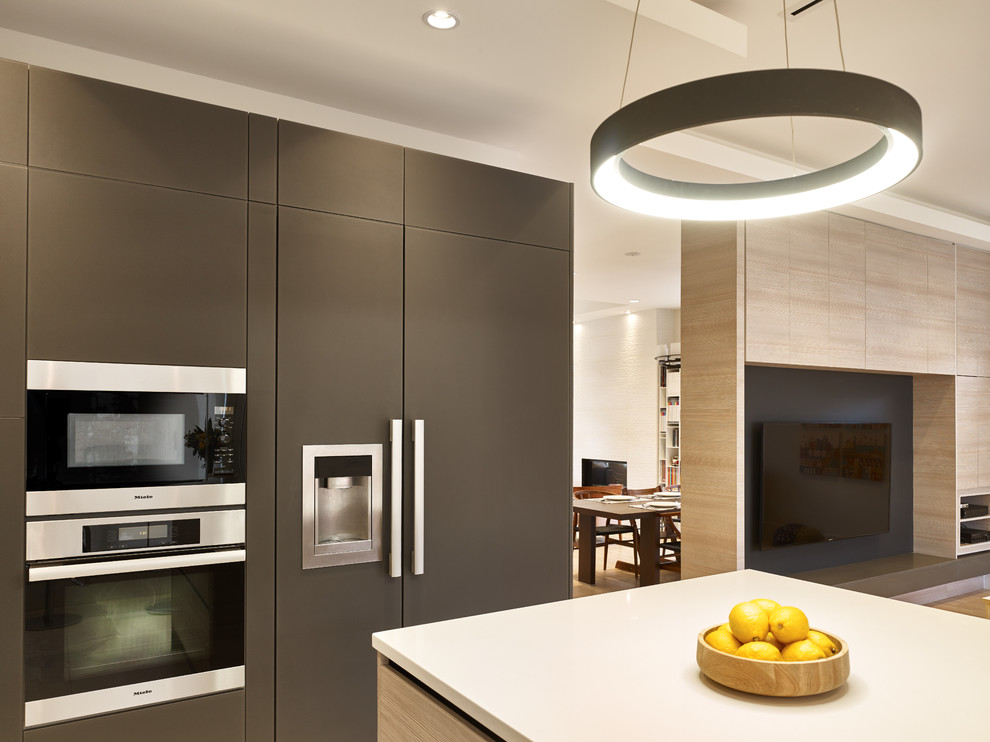 Trendy u-shaped ceramic tile kitchen photo in Vancouver with an undermount sink, flat-panel cabinets, quartz countertops, white backsplash, glass tile backsplash, paneled appliances and an island