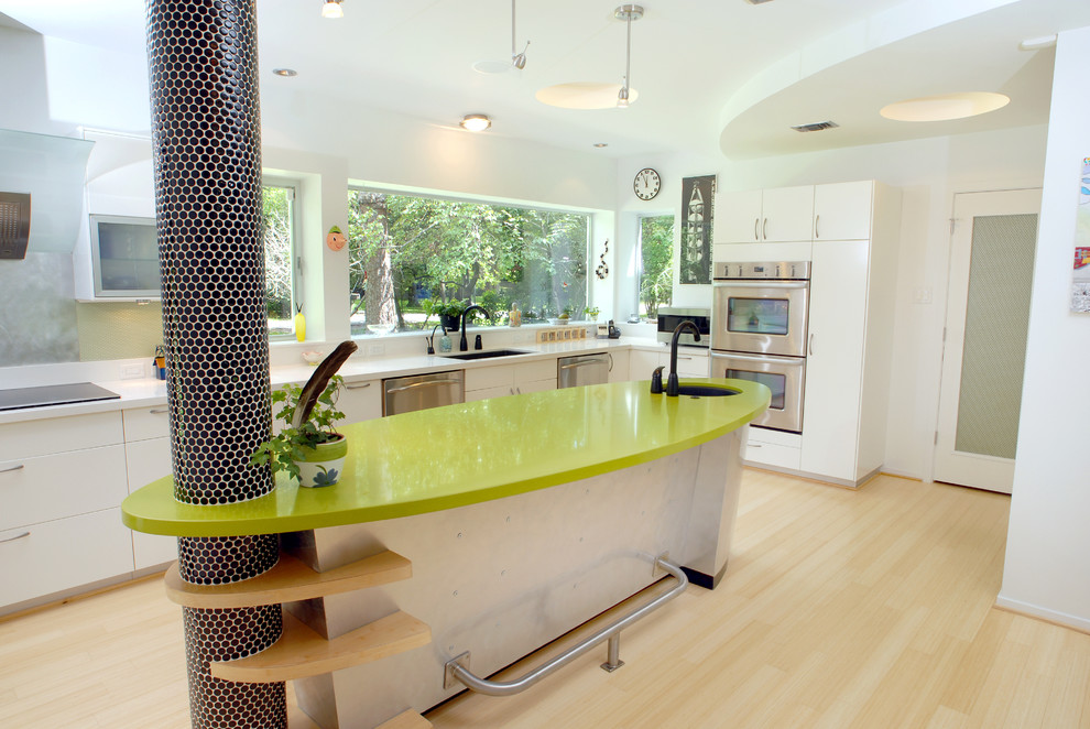Inspiration for an eclectic kitchen remodel in Houston with stainless steel appliances, quartz countertops and green countertops