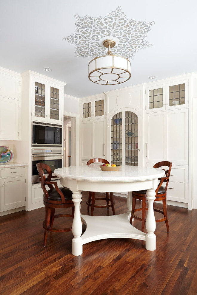 Eat-in kitchen - traditional eat-in kitchen idea in Minneapolis with shaker cabinets, white cabinets and paneled appliances