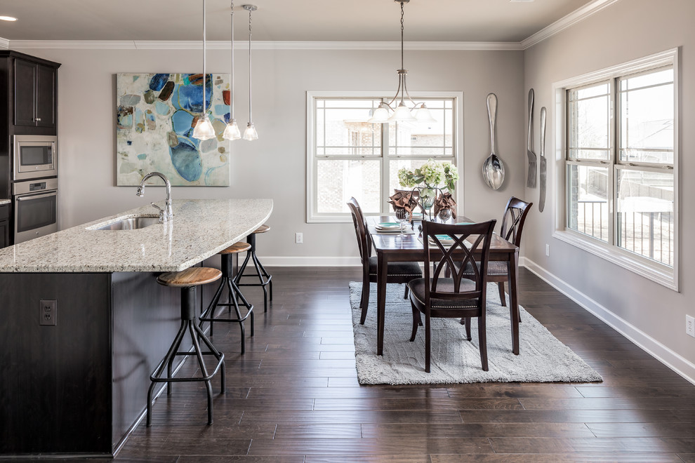 Inspiration for a mid-sized transitional single-wall dark wood floor eat-in kitchen remodel in Other with an undermount sink, recessed-panel cabinets, dark wood cabinets, granite countertops, white backsplash, subway tile backsplash, white appliances and an island