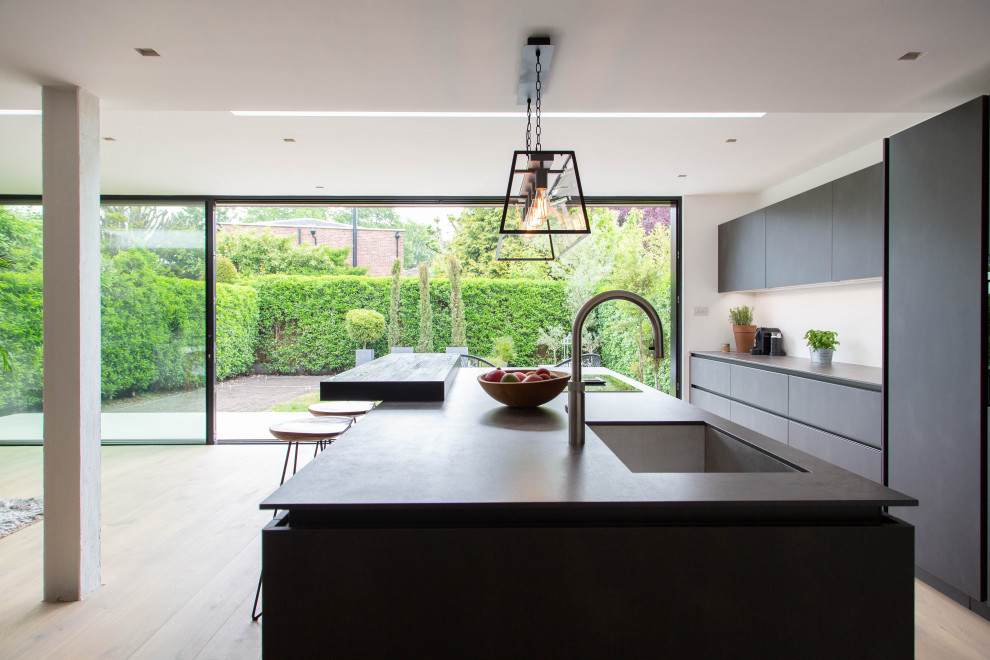 Expansive contemporary open plan kitchen in London with an island.