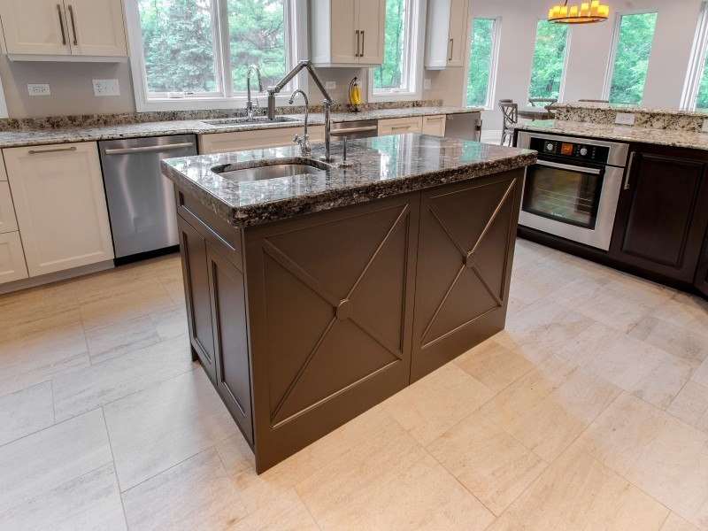 Example of a classic kitchen design in Chicago with granite countertops and two islands