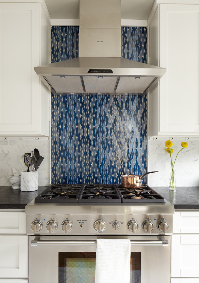 Example of a mid-sized classic single-wall light wood floor eat-in kitchen design in Seattle with blue backsplash, stainless steel appliances, an undermount sink, shaker cabinets, white cabinets, onyx countertops, stone tile backsplash and no island