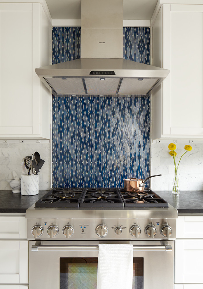 Example of a mid-sized classic light wood floor eat-in kitchen design in Seattle with blue backsplash, stainless steel appliances, an undermount sink, shaker cabinets, white cabinets, onyx countertops, stone tile backsplash and no island