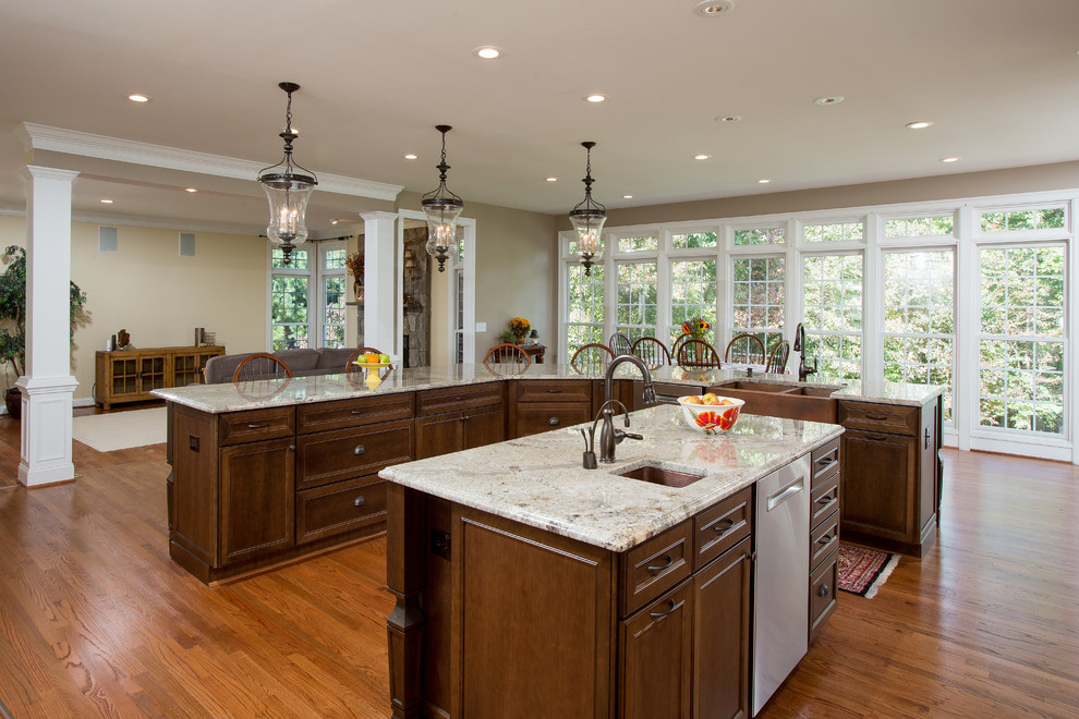 Inspiration for a large timeless light wood floor kitchen remodel in DC Metro with white cabinets, granite countertops, beige backsplash, stainless steel appliances and two islands