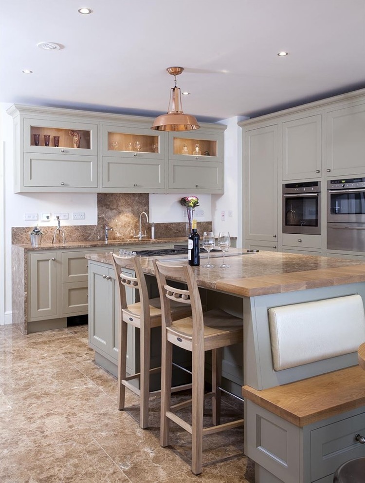 Inspiration for a timeless l-shaped kitchen remodel in Dublin with an undermount sink, recessed-panel cabinets, green cabinets, brown backsplash and stainless steel appliances
