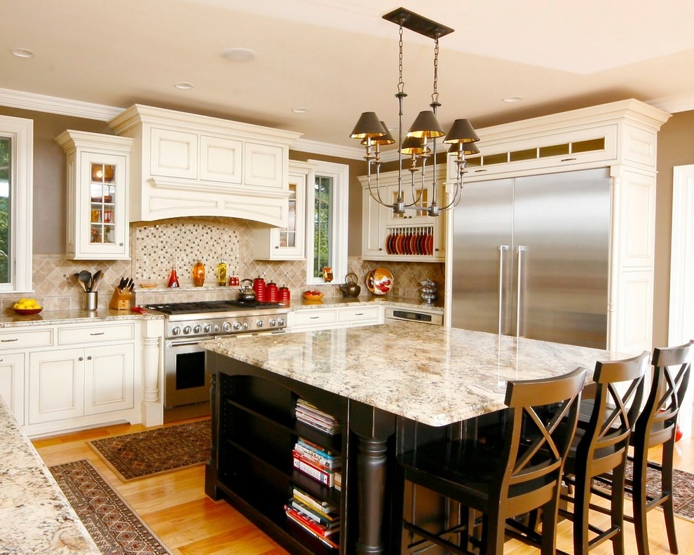 Example of a classic light wood floor kitchen pantry design in Boston with an undermount sink, beaded inset cabinets, beige cabinets, granite countertops, beige backsplash, ceramic backsplash, stainless steel appliances and an island