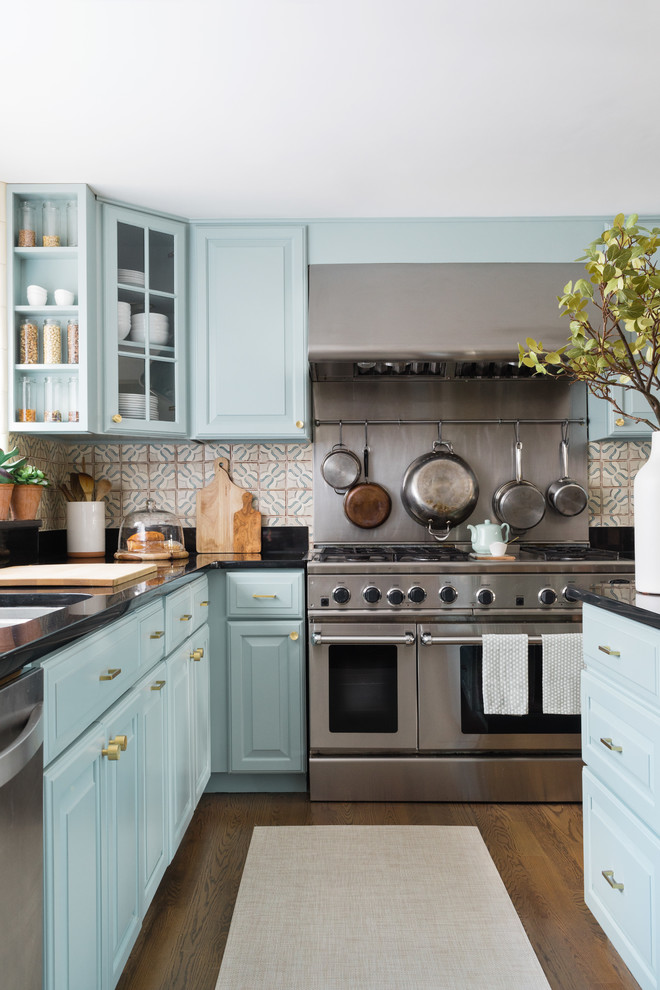 Medium sized traditional grey and cream l-shaped kitchen/diner in Boston with blue cabinets, terracotta splashback, an island, raised-panel cabinets, multi-coloured splashback, stainless steel appliances, a submerged sink, engineered stone countertops, medium hardwood flooring and brown floors.