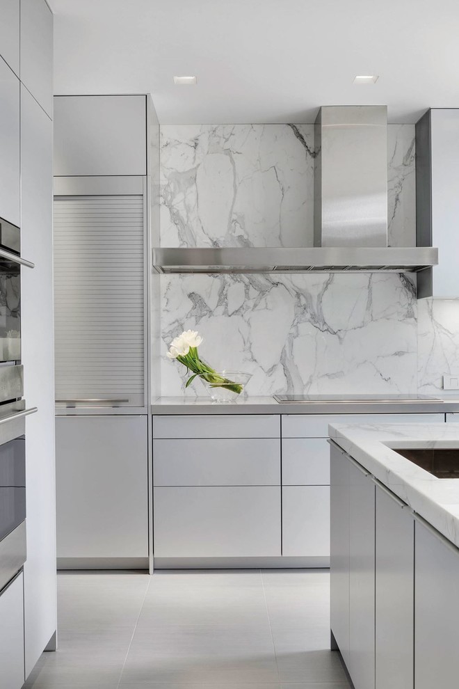 Inspiration for a small contemporary galley porcelain tile kitchen pantry remodel in Boston with a drop-in sink, flat-panel cabinets, light wood cabinets, marble countertops, multicolored backsplash, stone slab backsplash, stainless steel appliances and an island