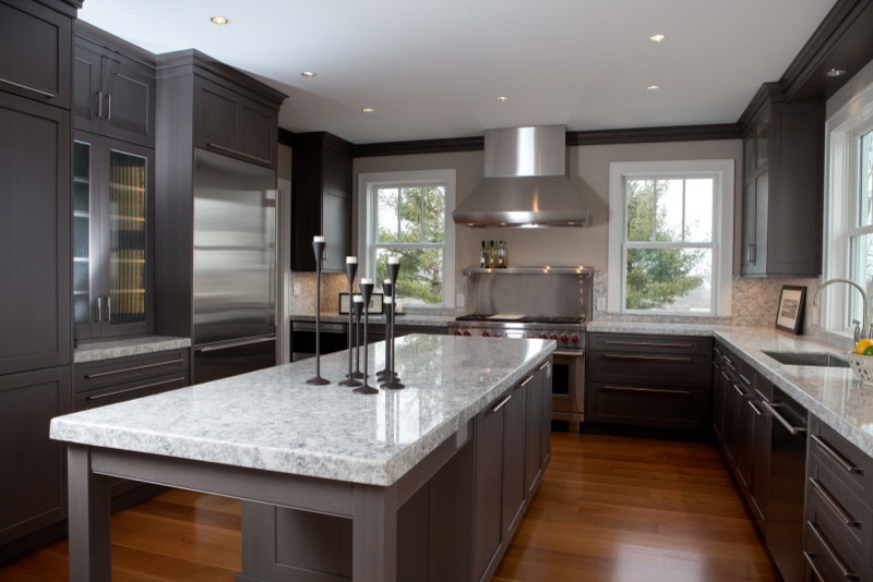 Exempel på ett avskilt, stort modernt u-kök, med en undermonterad diskho, grå skåp, bänkskiva i kvarts, rostfria vitvaror, en köksö, luckor med glaspanel och mellanmörkt trägolv