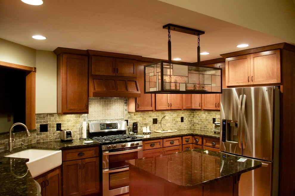 Bild på ett mellanstort amerikanskt kök, med en rustik diskho, skåp i shakerstil, skåp i mellenmörkt trä, granitbänkskiva, grönt stänkskydd, stänkskydd i stenkakel, rostfria vitvaror, mellanmörkt trägolv och en köksö
