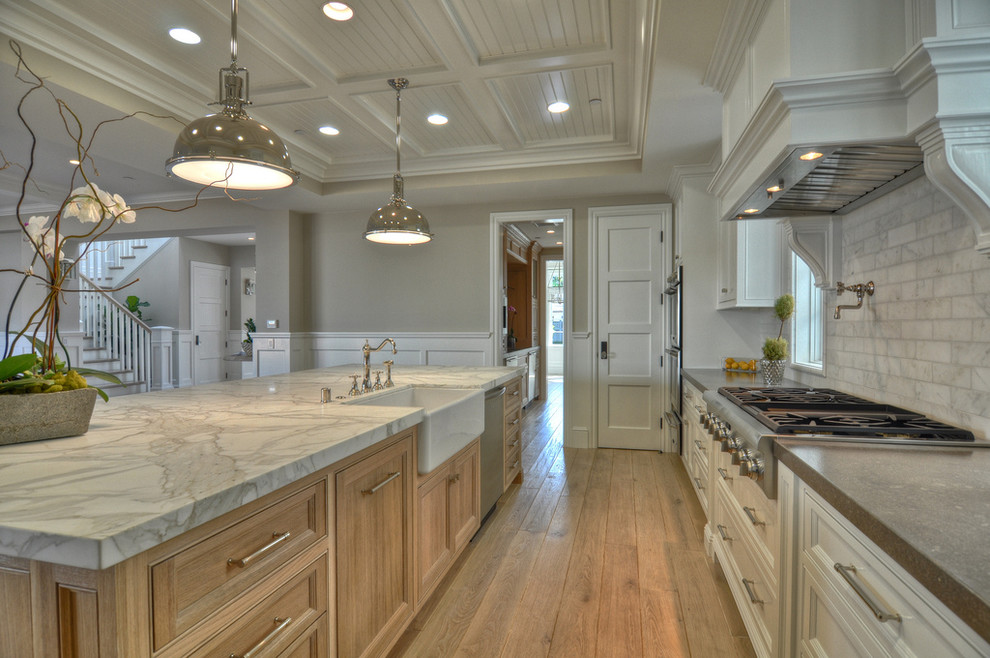 Photo of a classic kitchen in Orange County with stainless steel appliances and a belfast sink.