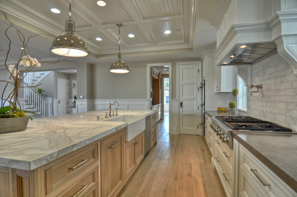 Elegant kitchen photo in Orange County with stainless steel appliances and a farmhouse sink