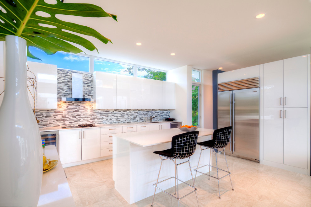 Large trendy u-shaped ceramic tile and beige floor kitchen photo in Tampa with an undermount sink, flat-panel cabinets, white cabinets, solid surface countertops, multicolored backsplash, matchstick tile backsplash, stainless steel appliances, an island and white countertops