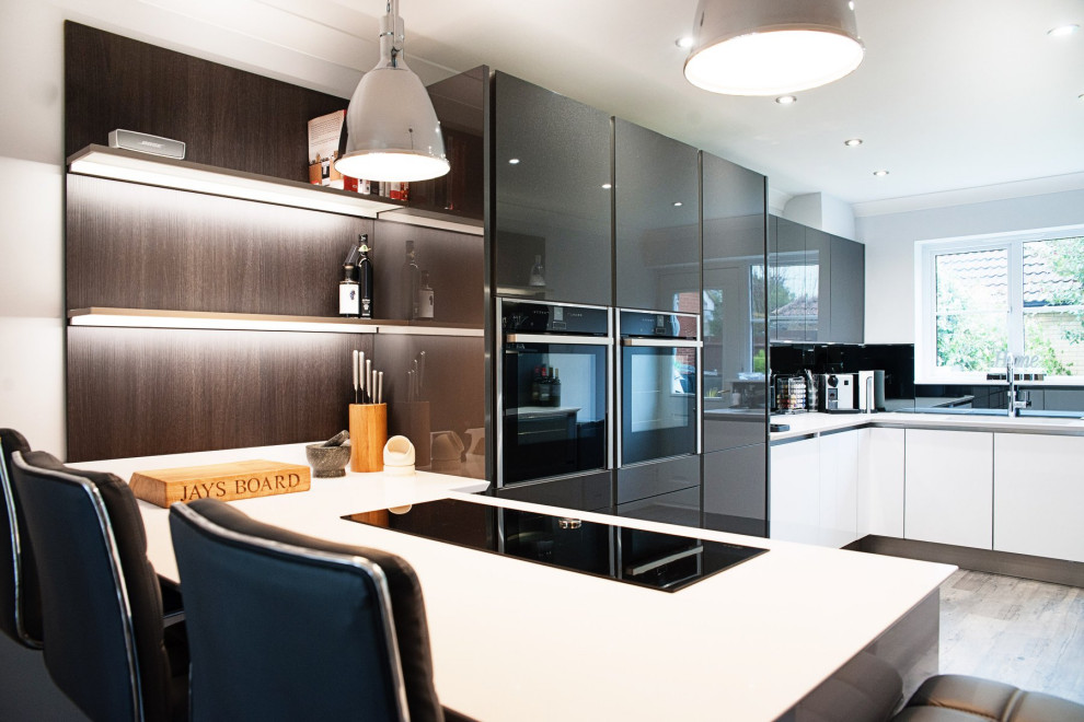 Medium sized modern kitchen in Essex with white cabinets and quartz worktops.