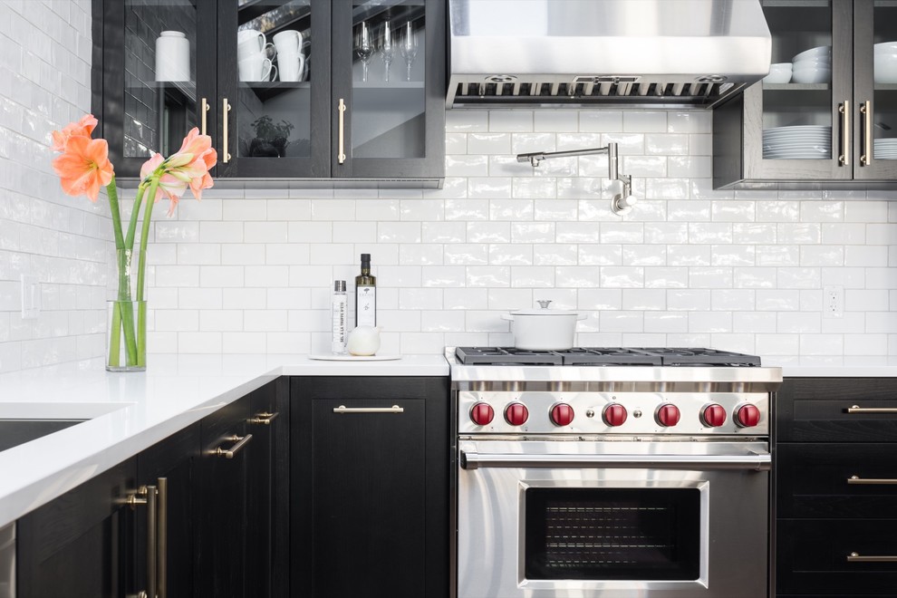 Transitional kitchen photo in Calgary with shaker cabinets, black cabinets, white backsplash and subway tile backsplash