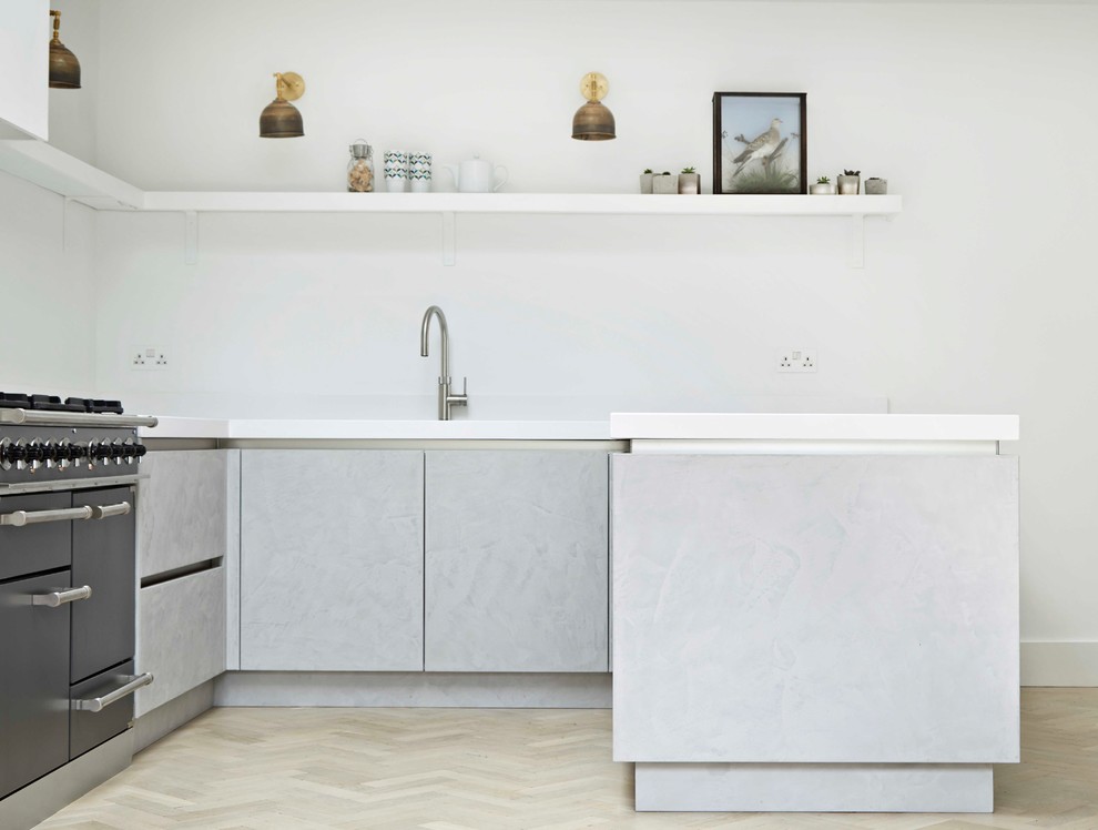 Inspiration for a large industrial u-shaped kitchen/diner in London with a double-bowl sink, flat-panel cabinets, grey cabinets, quartz worktops, white splashback, light hardwood flooring and yellow floors.