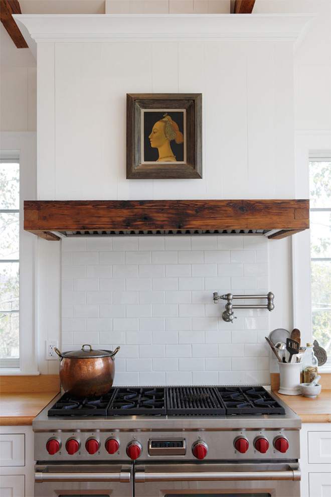 Kitchen - cottage kitchen idea in Philadelphia with white cabinets, wood countertops, white backsplash, subway tile backsplash and stainless steel appliances