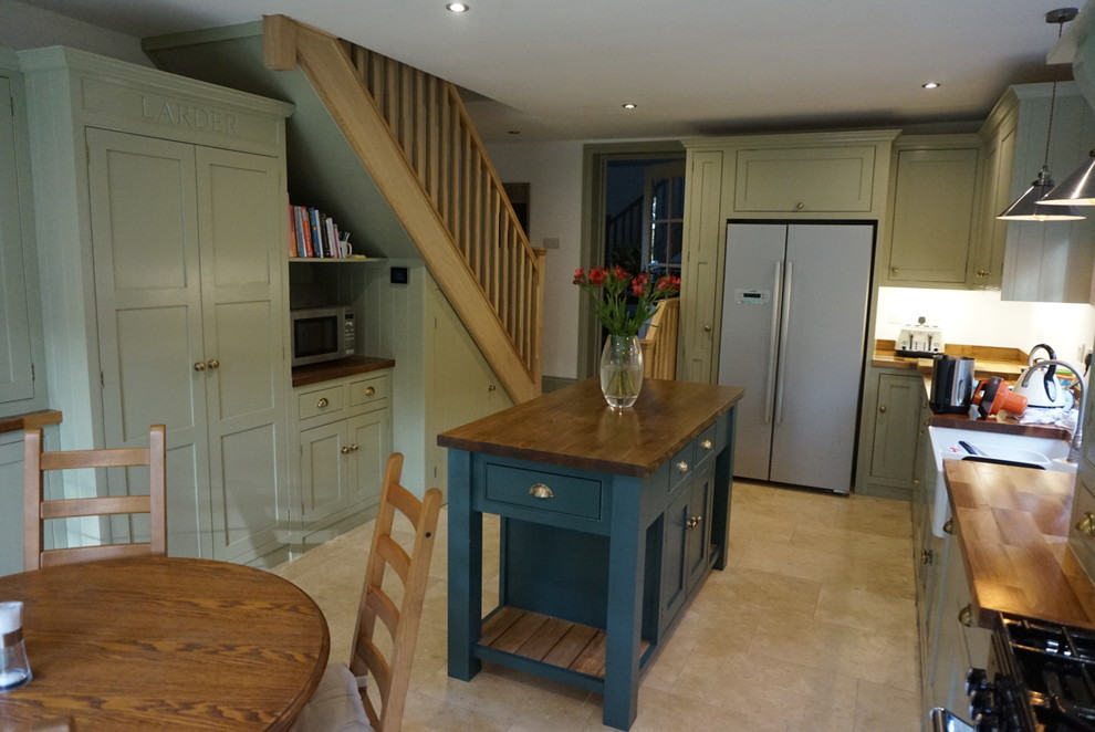 Inspiration for a mid-sized cottage l-shaped kitchen remodel in Surrey with beaded inset cabinets, green cabinets, wood countertops and an island