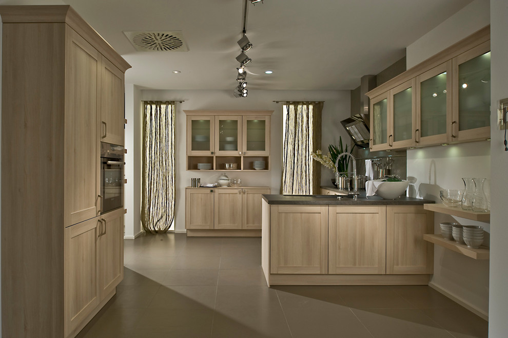 Design ideas for a country kitchen in London with shaker cabinets, light wood cabinets and a breakfast bar.