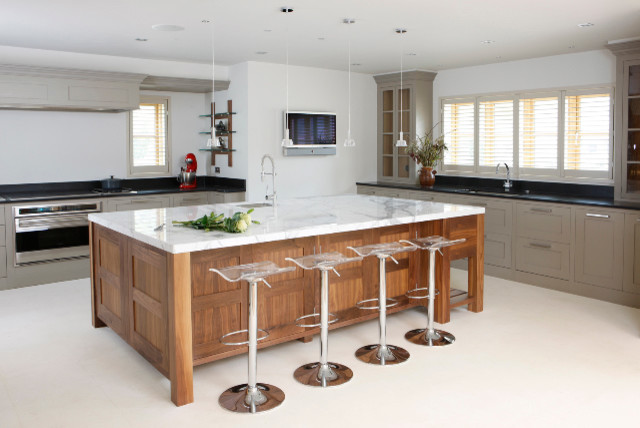 Modern u-shaped kitchen in West Midlands with an integrated sink, shaker cabinets, marble worktops, integrated appliances, porcelain flooring and an island.