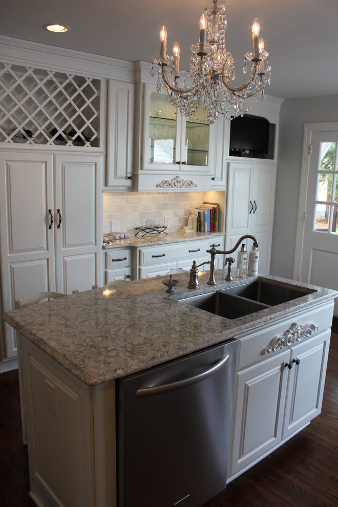 Design ideas for a traditional u-shaped kitchen/diner in Louisville with a submerged sink, raised-panel cabinets, white cabinets, engineered stone countertops and stainless steel appliances.