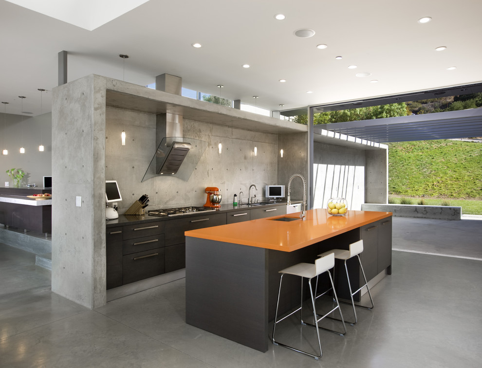 Inspiration for a modern kitchen in Los Angeles with a submerged sink, flat-panel cabinets, brown cabinets and orange worktops.
