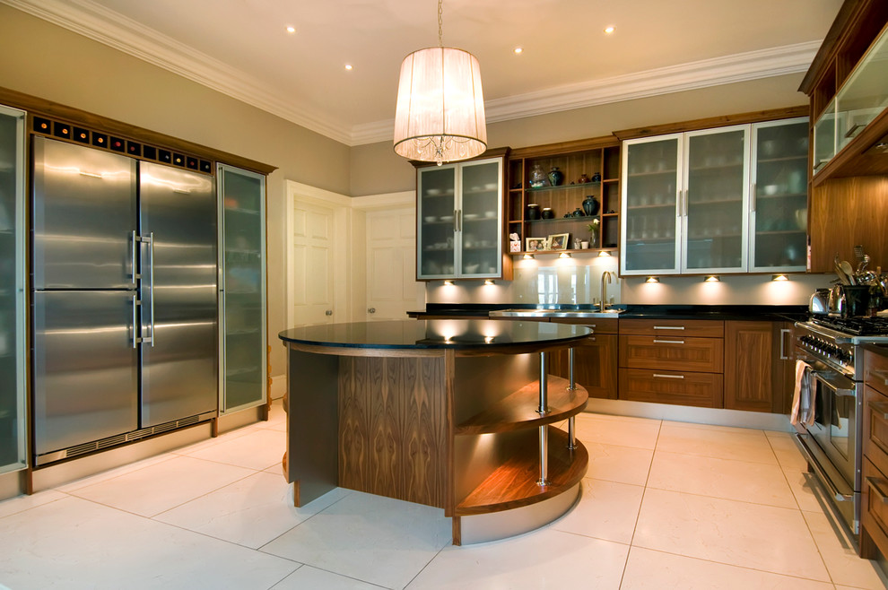 Photo of a contemporary kitchen in Limerick with glass-front cabinets and stainless steel appliances.