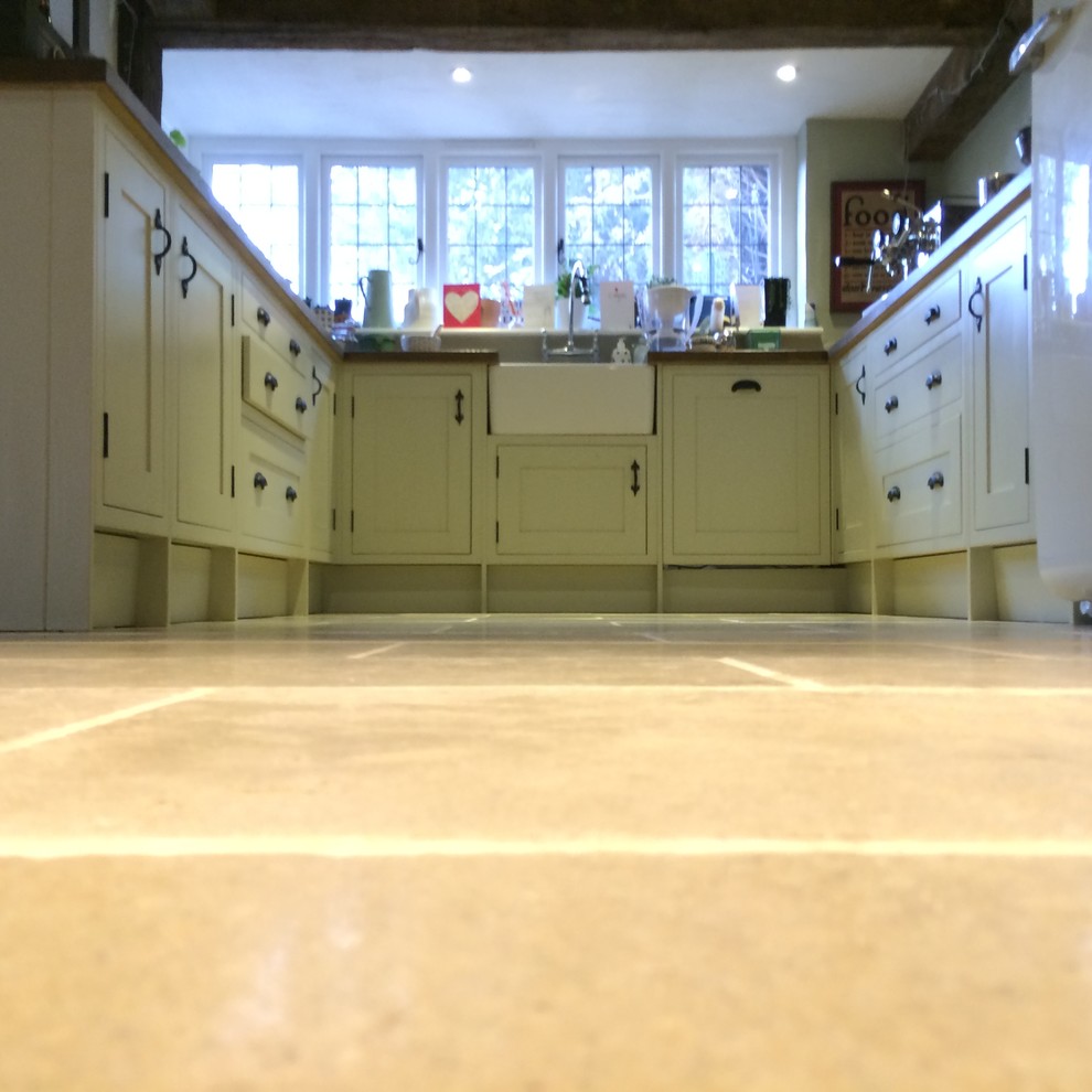 Photo of a farmhouse kitchen in Other with marble flooring.