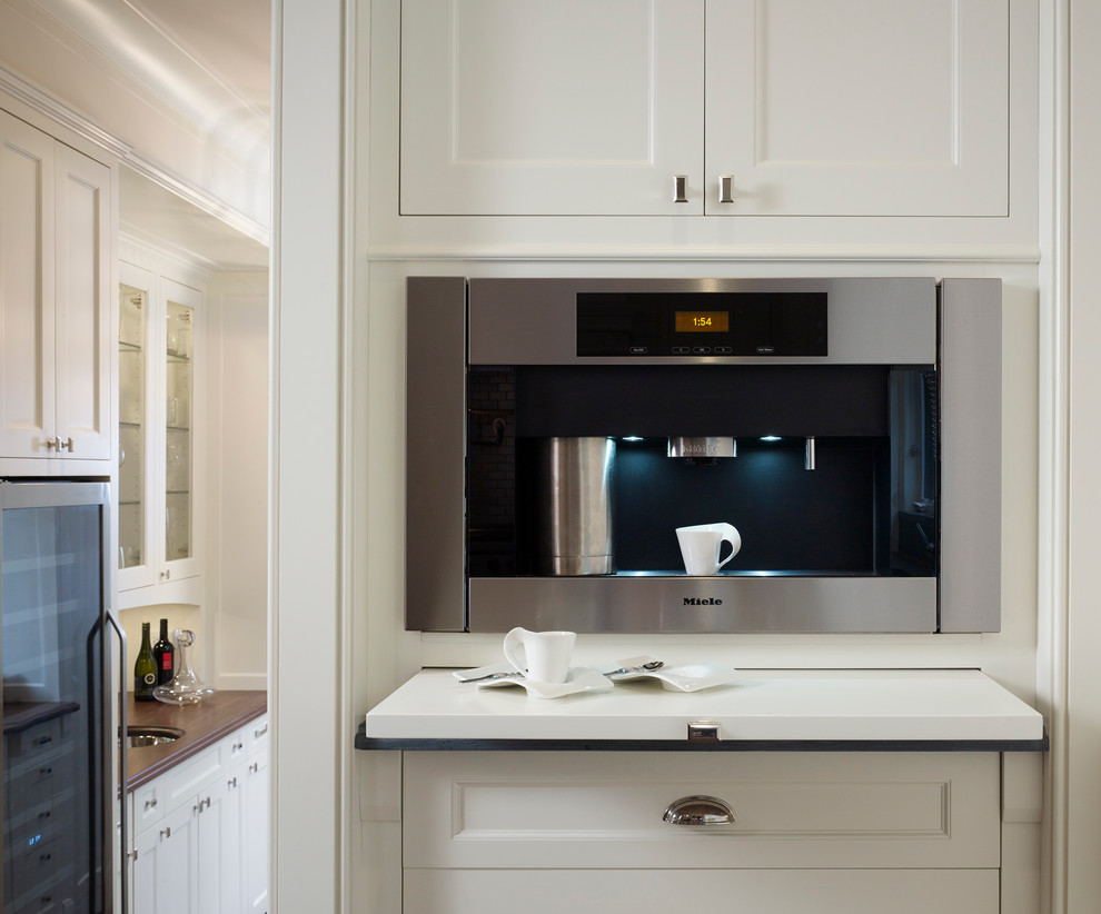 Example of a large classic u-shaped dark wood floor open concept kitchen design in Chicago with a farmhouse sink, recessed-panel cabinets, white cabinets, marble countertops, metal backsplash, paneled appliances and an island