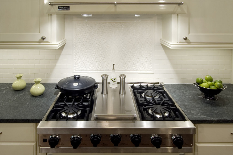 Kitchen - traditional kitchen idea in Chicago with stainless steel appliances, soapstone countertops and white backsplash