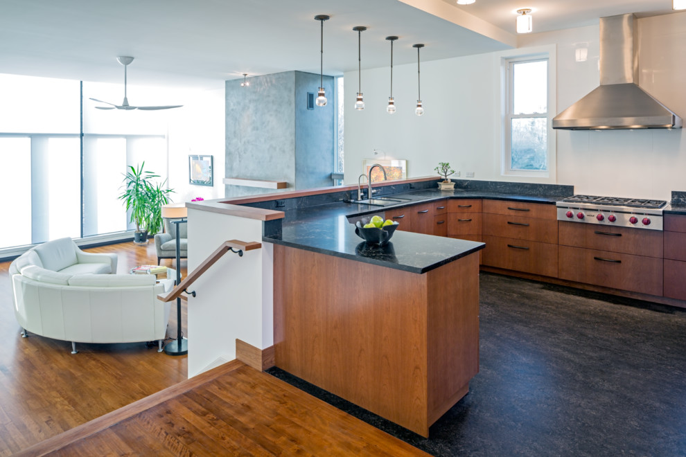 This is an example of a modern u-shaped open plan kitchen in Toronto with a built-in sink, flat-panel cabinets, medium wood cabinets, quartz worktops, white splashback, porcelain splashback, stainless steel appliances, lino flooring and a breakfast bar.