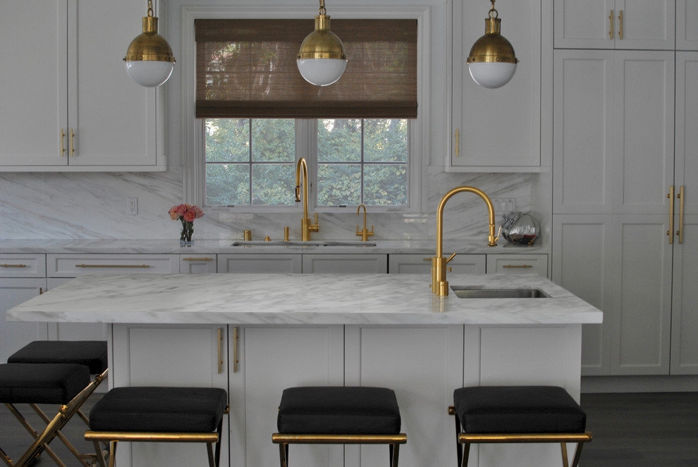 Example of a transitional dark wood floor kitchen design in Los Angeles with an undermount sink, recessed-panel cabinets, white cabinets, white backsplash and an island