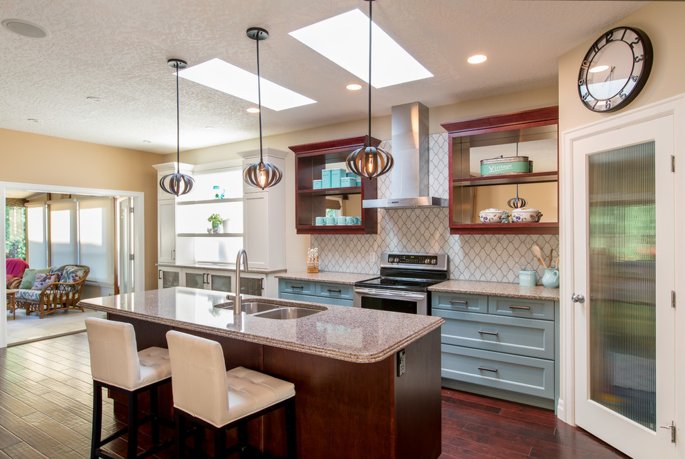 Kitchen - mid-sized eclectic l-shaped dark wood floor and brown floor kitchen idea in Vancouver with a double-bowl sink, shaker cabinets, turquoise cabinets, quartzite countertops, white backsplash, marble backsplash, stainless steel appliances and an island