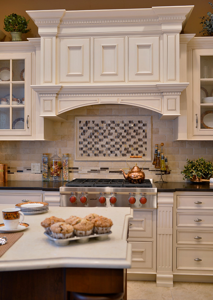 Traditional l-shaped kitchen/diner in New York with a single-bowl sink, recessed-panel cabinets, white cabinets, engineered stone countertops, integrated appliances and an island.