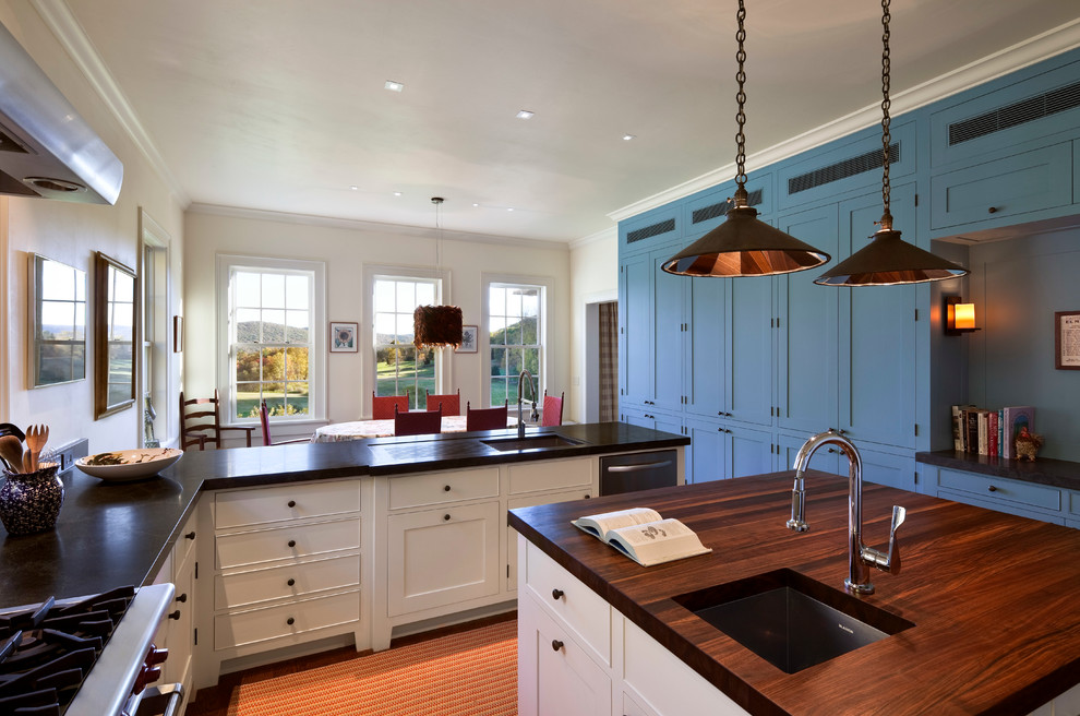 This is an example of a traditional kitchen in New York with shaker cabinets, wood worktops and blue cabinets.