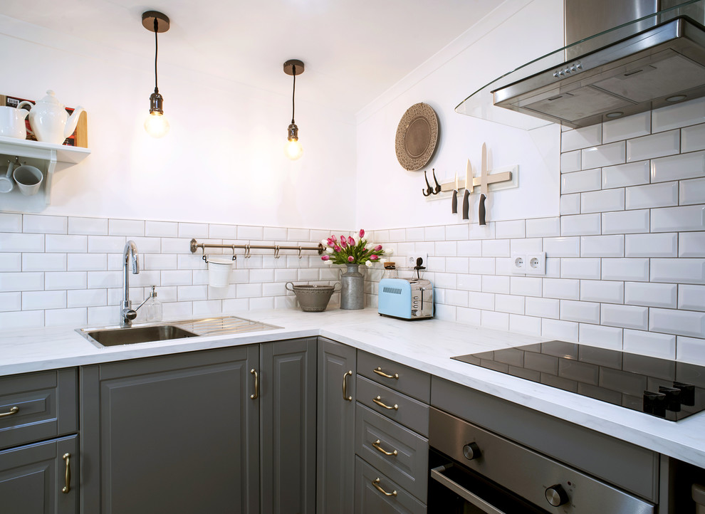 Design ideas for a small vintage l-shaped kitchen/diner in Other with a single-bowl sink, raised-panel cabinets, white cabinets, wood worktops, white splashback, metro tiled splashback, stainless steel appliances, ceramic flooring, no island and beige floors.