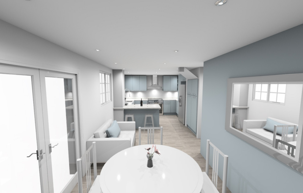 Foto på ett litet funkis vit kök, med en integrerad diskho, släta luckor, blå skåp, bänkskiva i kvartsit, rostfria vitvaror, mellanmörkt trägolv, en halv köksö och grått golv