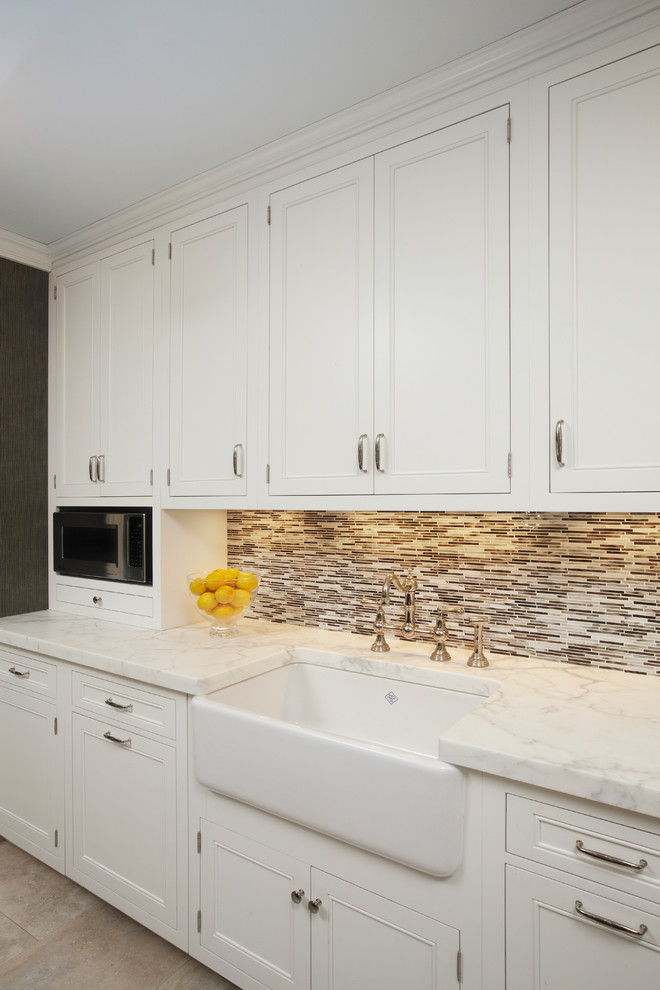 Inspiration for a large timeless u-shaped ceramic tile eat-in kitchen remodel in New York with a farmhouse sink, white cabinets, multicolored backsplash, paneled appliances, an island, recessed-panel cabinets, marble countertops and matchstick tile backsplash