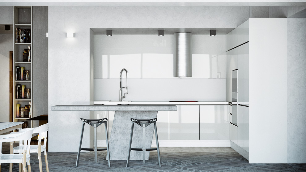This is an example of a large industrial l-shaped open plan kitchen in London with a built-in sink, flat-panel cabinets, white cabinets, concrete worktops, white splashback, glass tiled splashback, stainless steel appliances, ceramic flooring and an island.