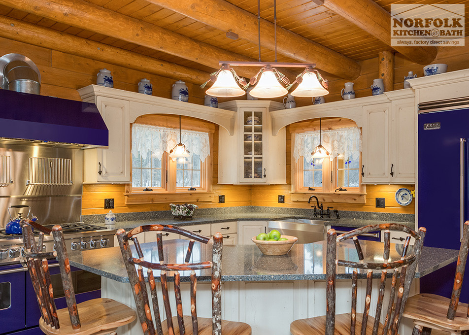 Example of a large farmhouse l-shaped open concept kitchen design in Boston with a farmhouse sink, raised-panel cabinets, white cabinets, quartz countertops, colored appliances and an island