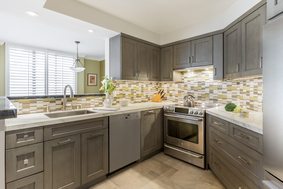 Inspiration for a transitional u-shaped beige floor kitchen remodel in San Francisco with an undermount sink, shaker cabinets, gray cabinets, multicolored backsplash, stainless steel appliances and white countertops
